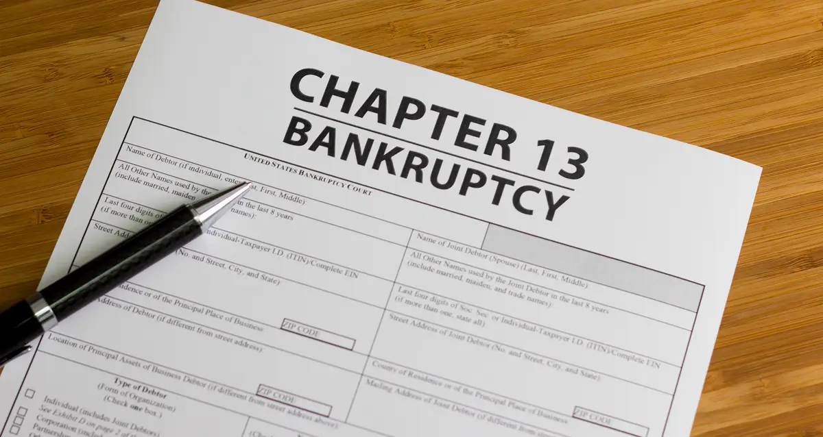 Bankruptcy paperwork on wooden desk